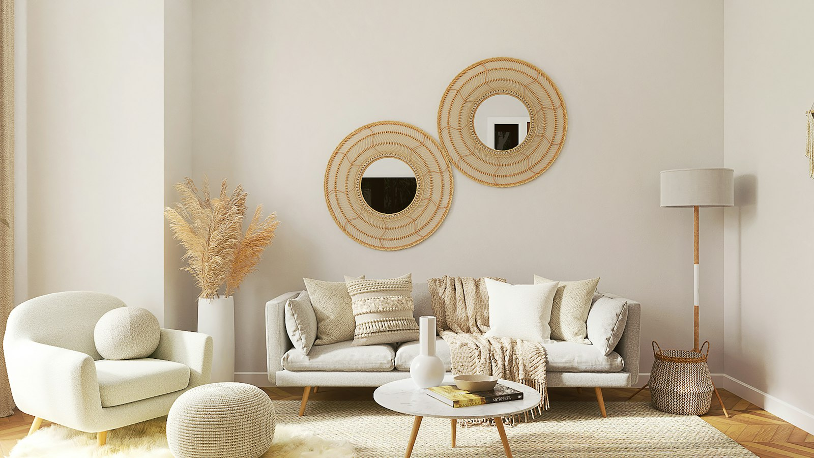 Sunlit living room with a curved cream sofa, round rattan mirrors and soft beige walls