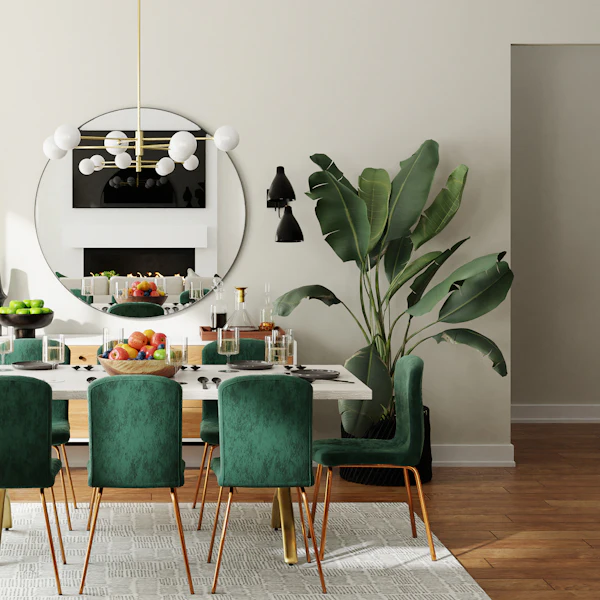 Dining room with emerald velvet chairs, a round mirror and tropical plants