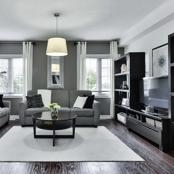 Living room with a grey sofa set, drum pendant light and patterned rug